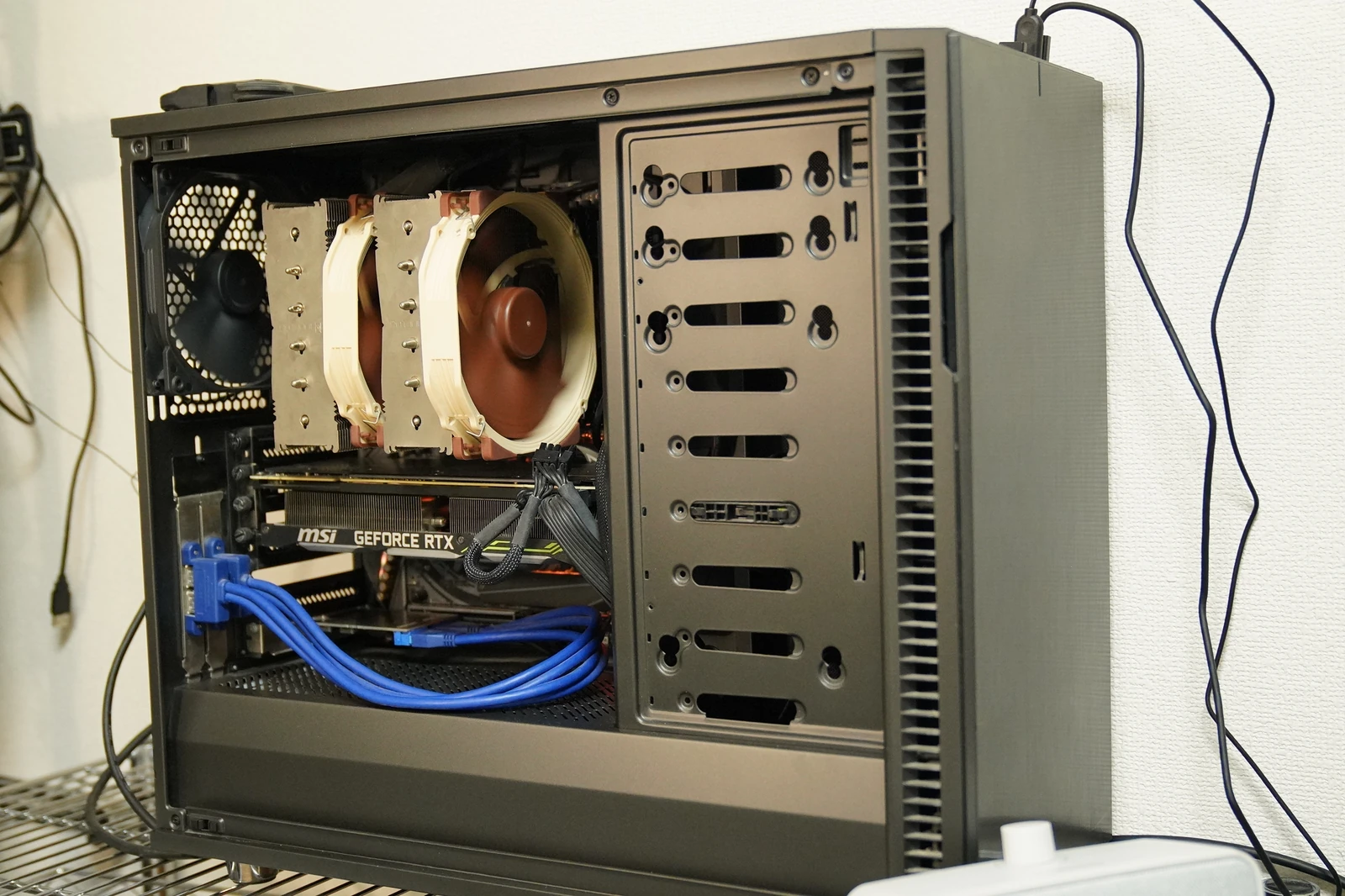 My former main PC with its side panel removed, showing a large Noctua CPU cooler and RTX 2080 Ti