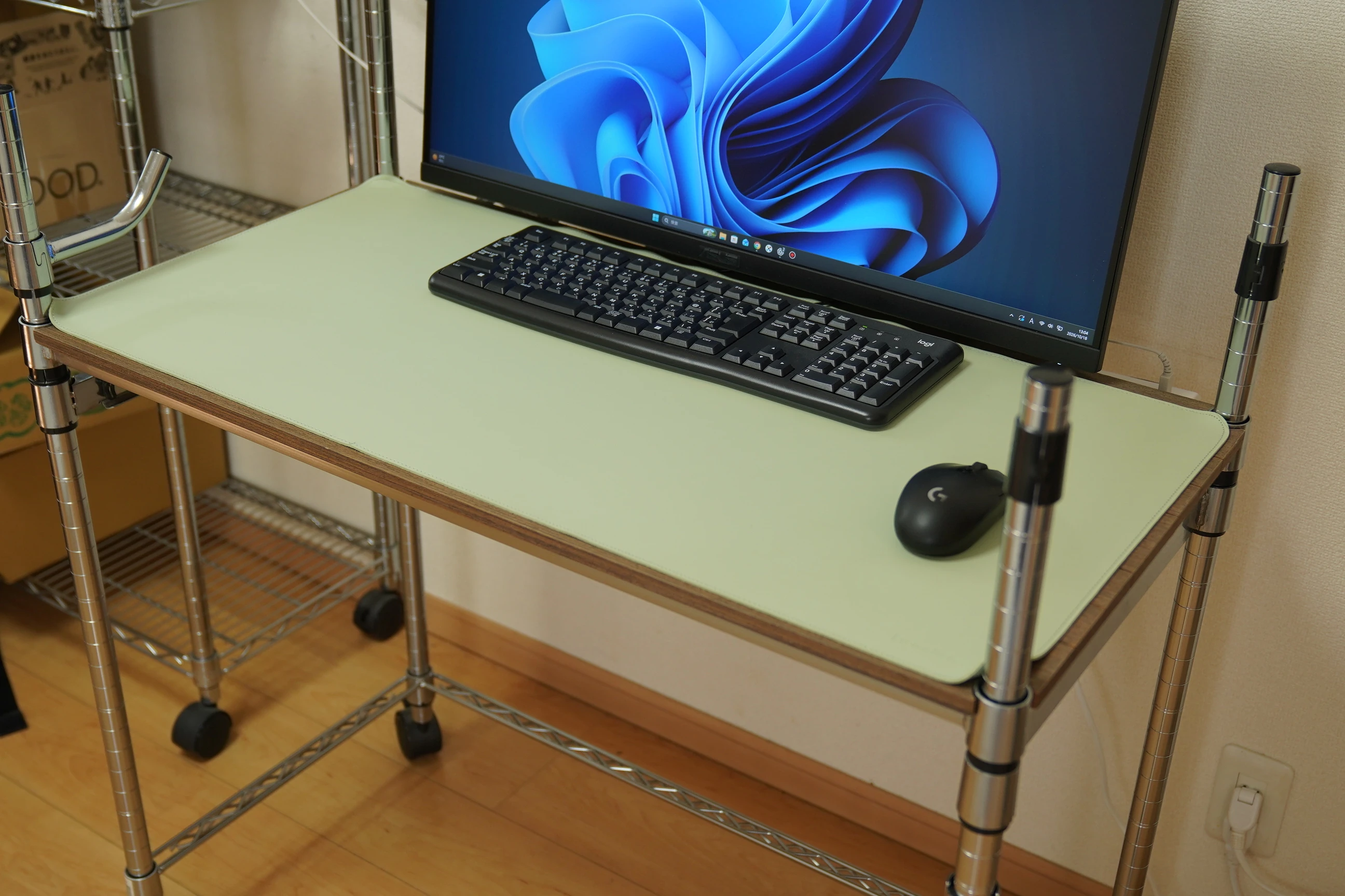 Keyboard and mouse on the freed work surface, with the monitor stand placed farther back